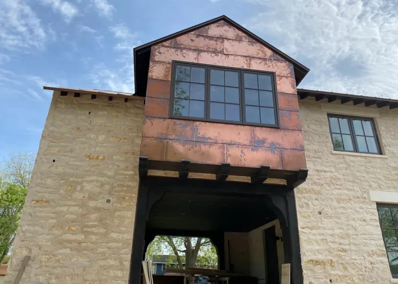 Copper metal panel facade on a stone building for Roof Repair in San Bernardino